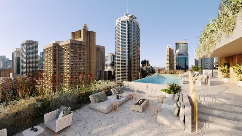 Rooftop terrace with a pool, planting and lounge seating, looking out over the Sydney skyline.